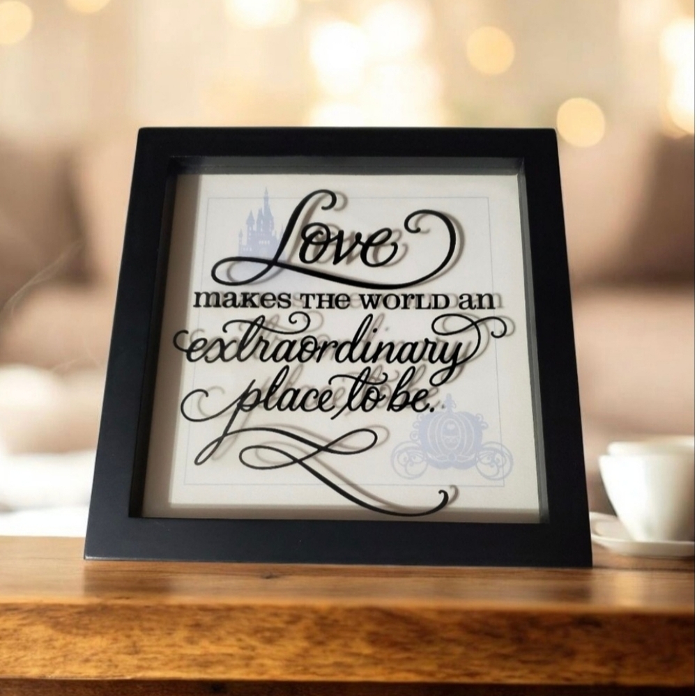 Disney by Hallmark Love makes the world sign